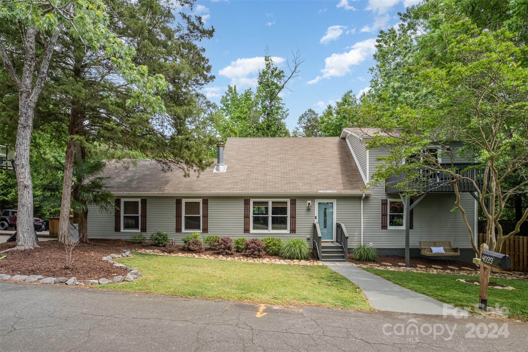4033 Windward Drive Tega Cay, SC 29708 - Photo 1 of 38 a front view of a house with a yard and porch