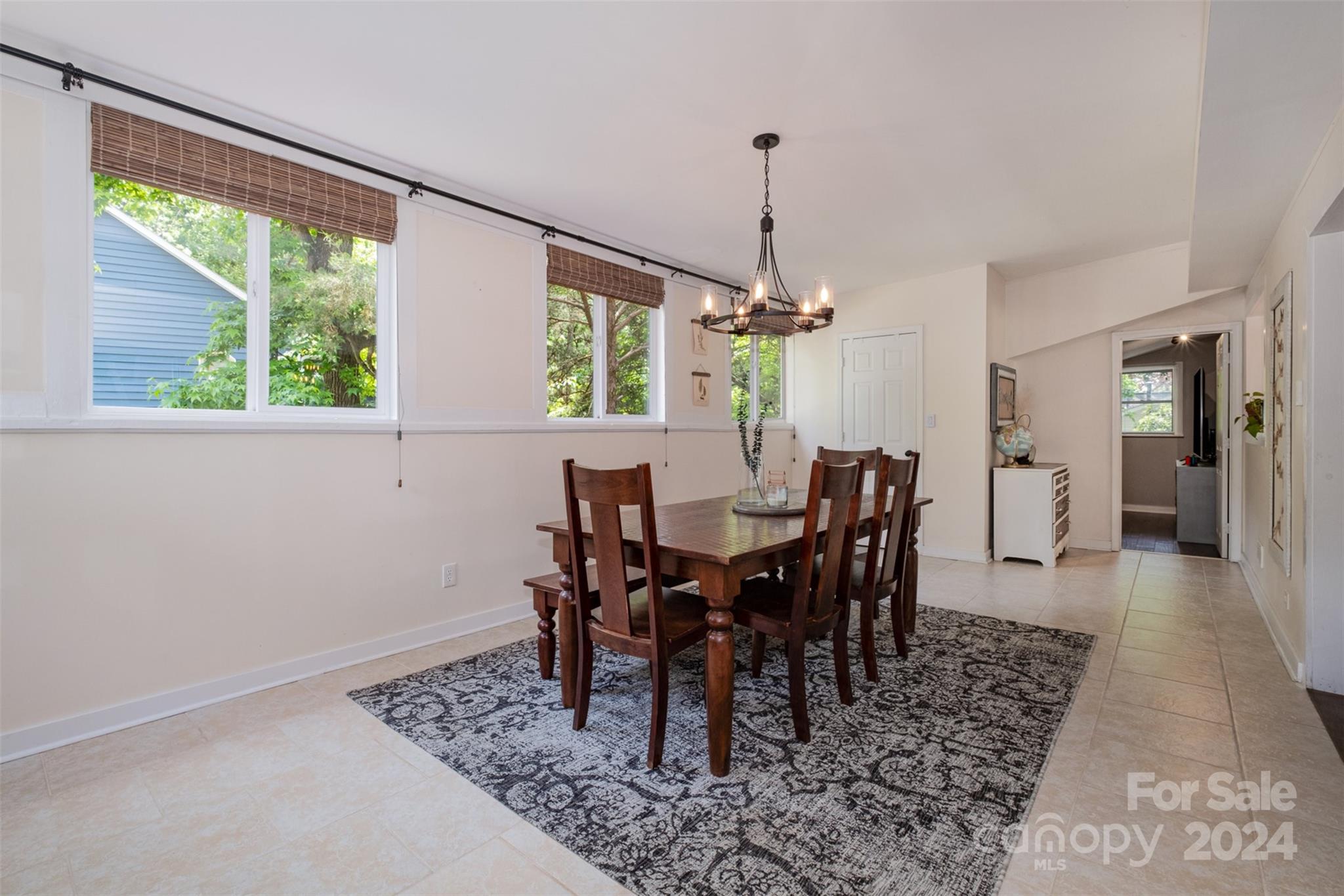 4033 Windward Drive Tega Cay, SC 29708 - Photo 12 of 38 a view of a dining room with furniture window and wooden floor