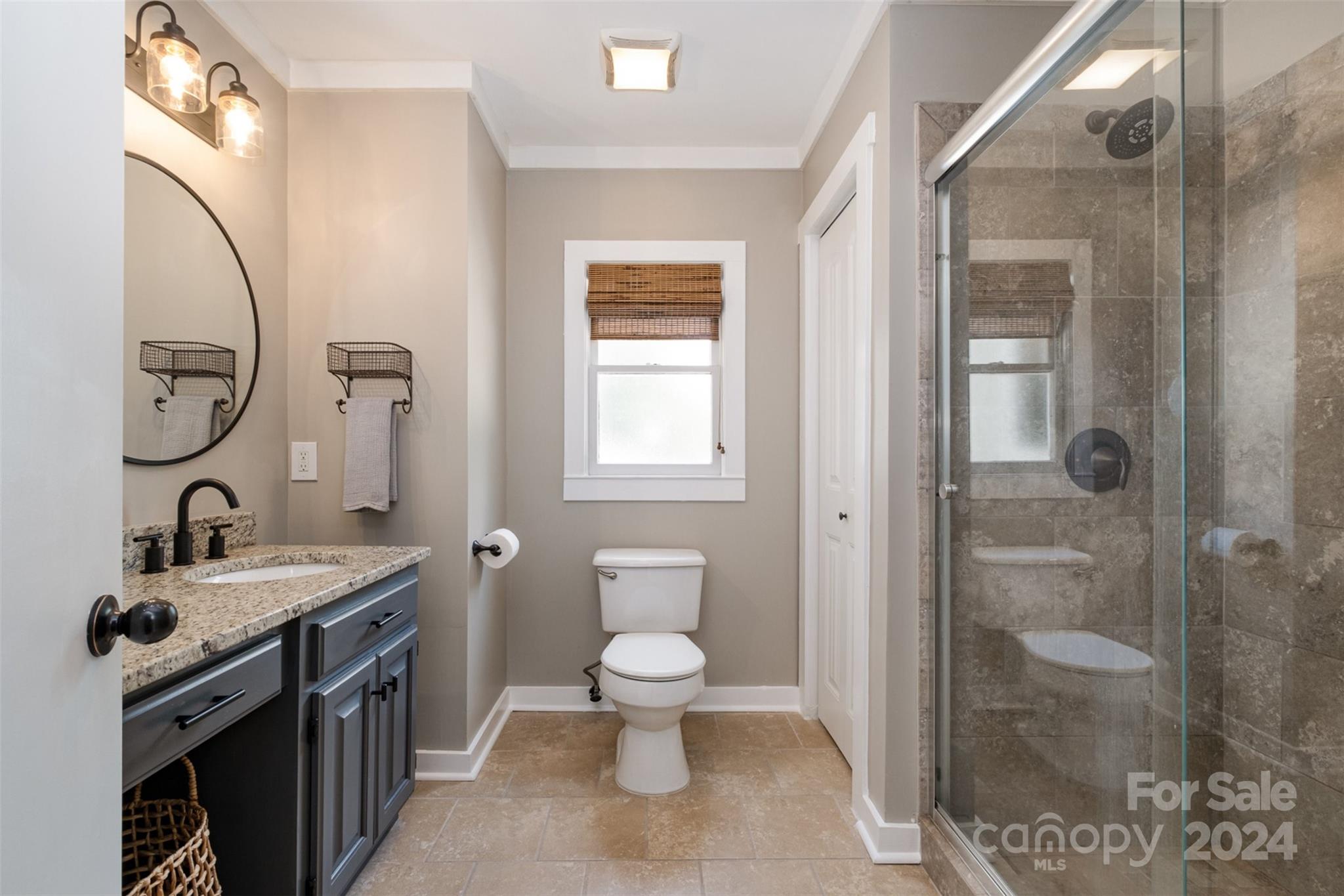4033 Windward Drive Tega Cay, SC 29708 - Photo 22 of 38 a bathroom with a toilet a sink and mirror