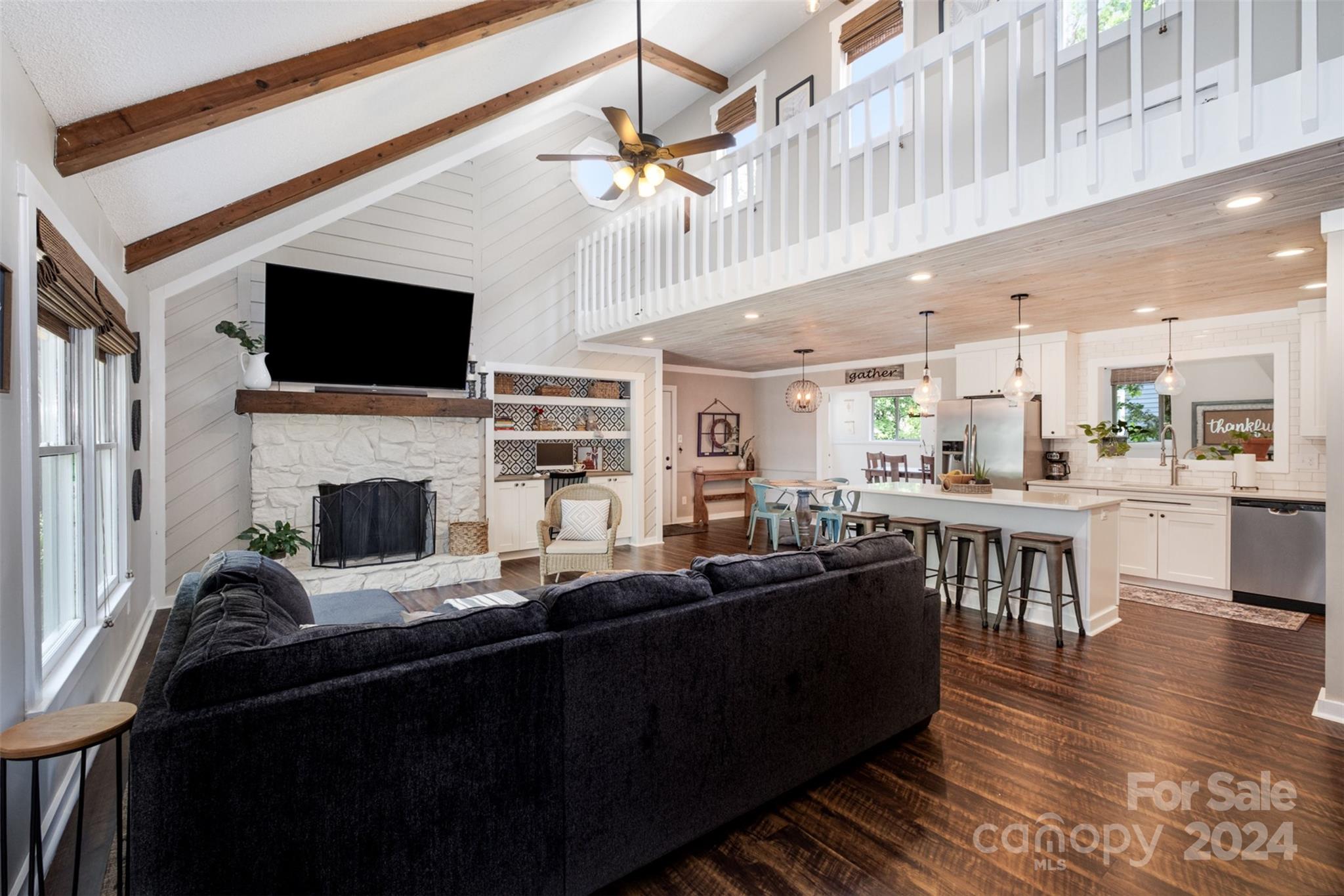 4033 Windward Drive Tega Cay, SC 29708 - Photo 3 of 38 a living room with furniture a fireplace and a flat screen tv