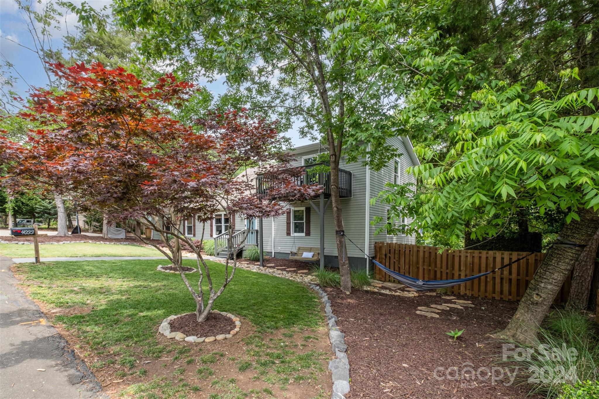 4033 Windward Drive Tega Cay, SC 29708 - Photo 32 of 38 a backyard of a house with plants and tree