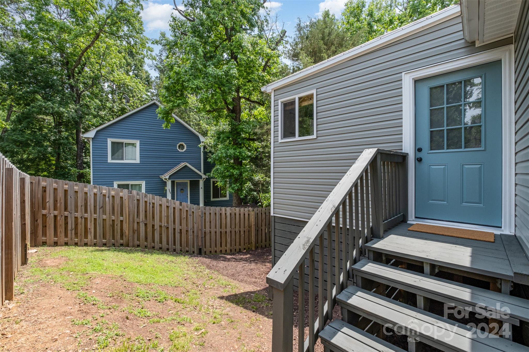 4033 Windward Drive Tega Cay, SC 29708 - Photo 33 of 38 a view of a house with wooden deck and a trees