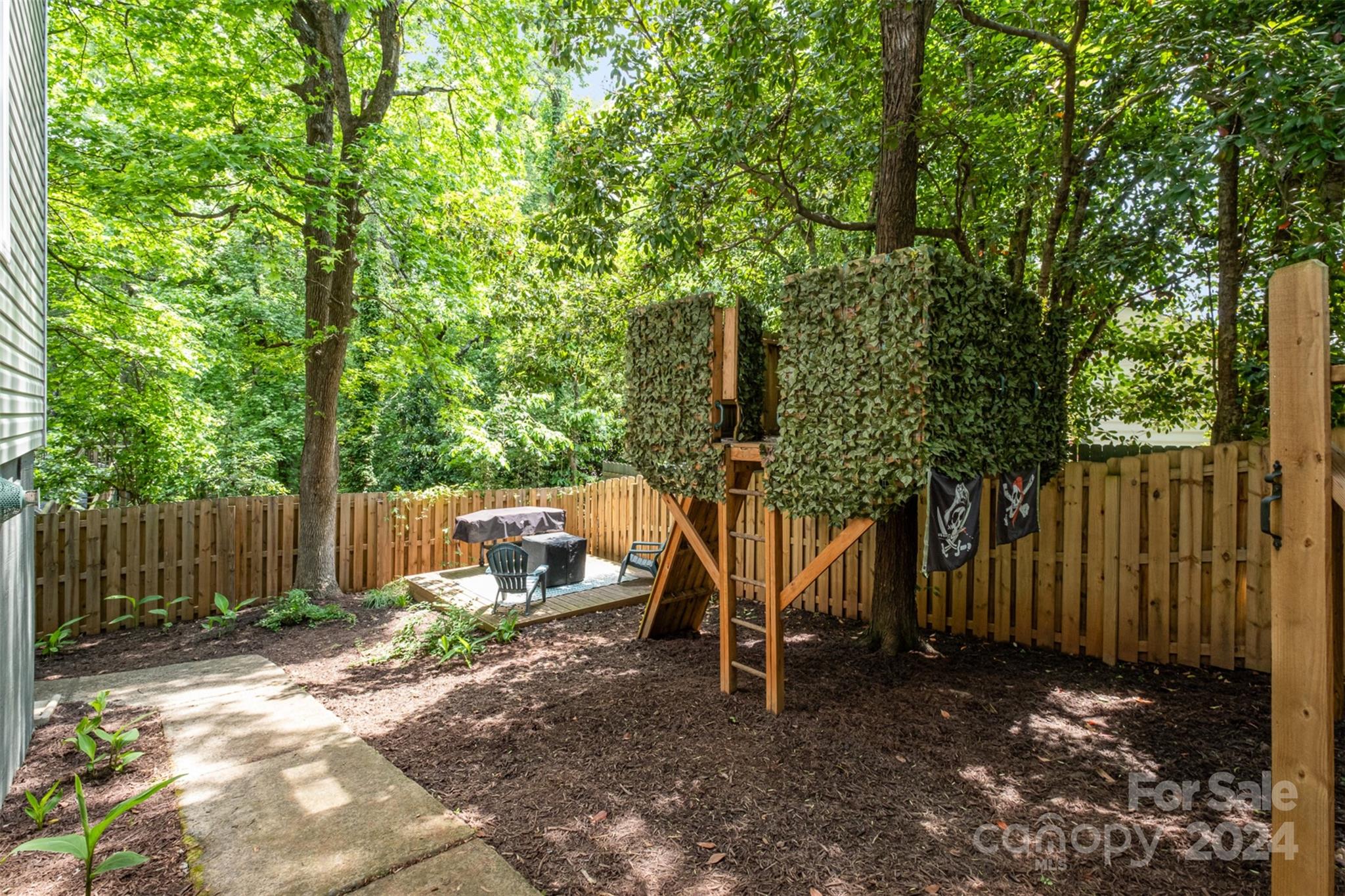 4033 Windward Drive Tega Cay, SC 29708 - Photo 37 of 38 a view of a park with large trees and wooden fence
