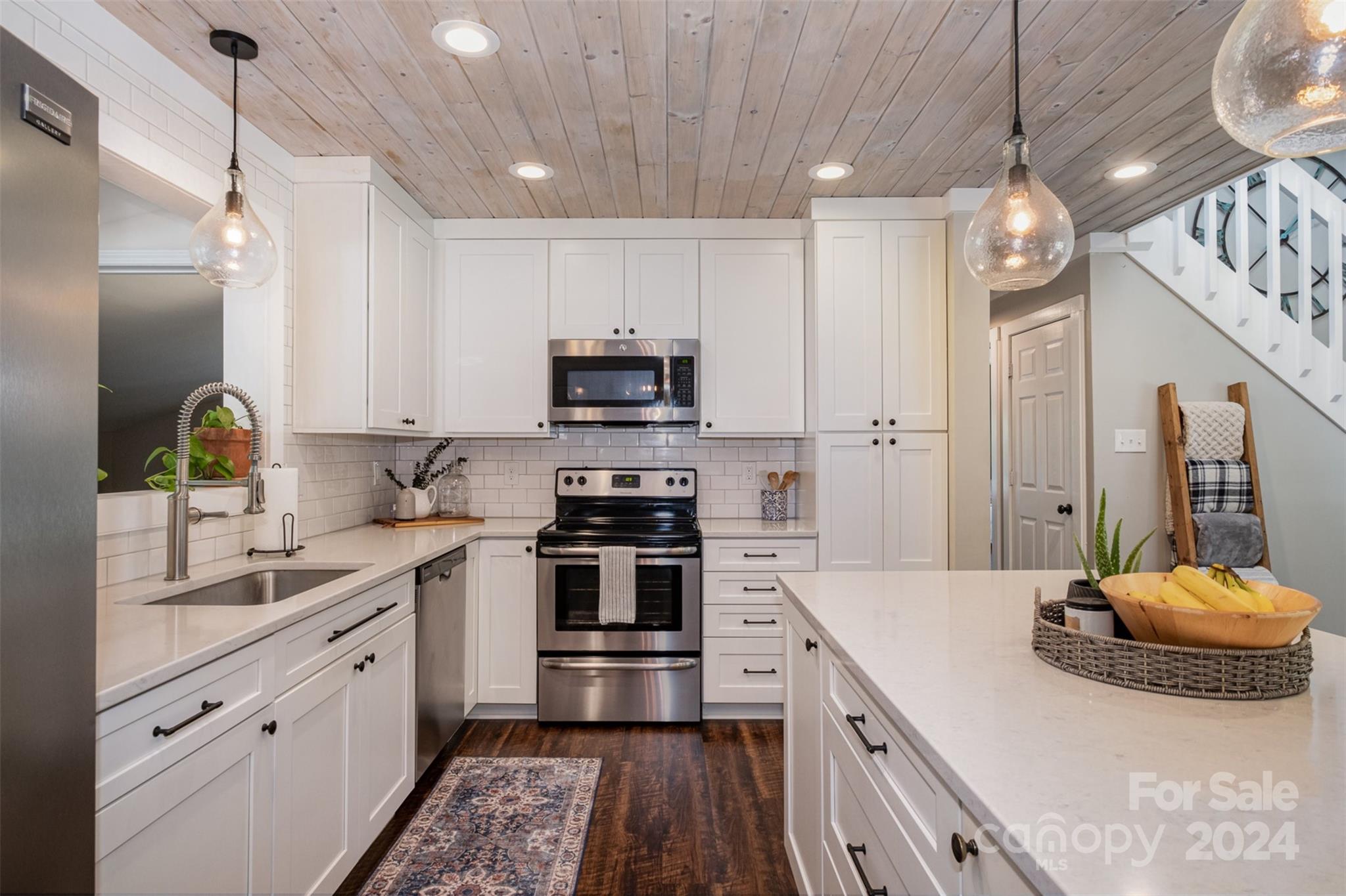 4033 Windward Drive Tega Cay, SC 29708 - Photo 7 of 38 a kitchen with stainless steel appliances granite countertop a sink a stove and a refrigerator