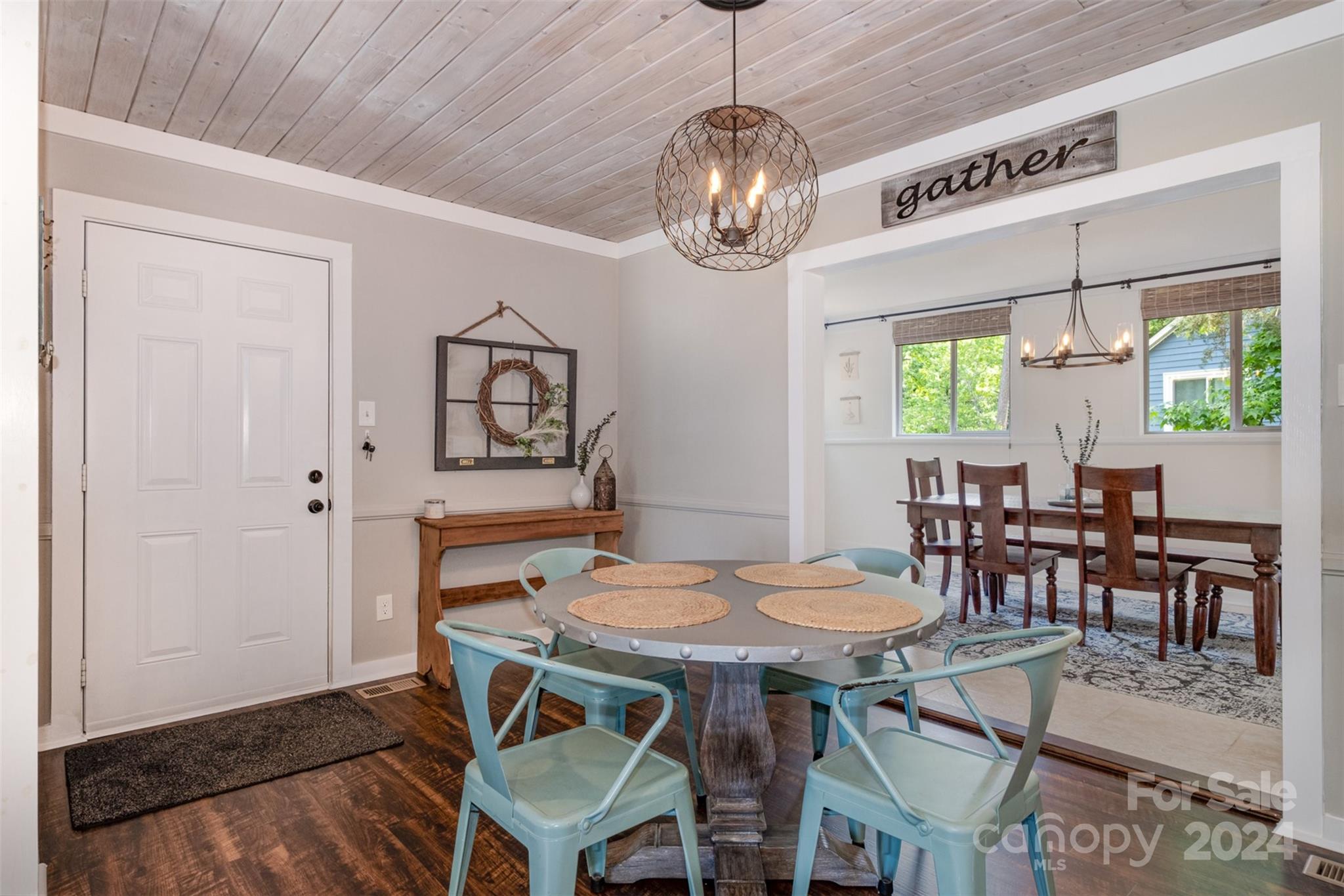 4033 Windward Drive Tega Cay, SC 29708 - Photo 9 of 38 a view of a dining room with furniture a chandelier and wooden floor