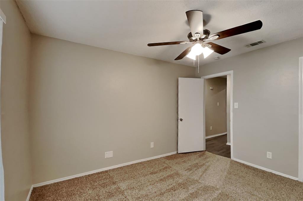 4013 David Circle Rowlett, TX 75088 - Photo 16 of 19 en view of an empty room and chandelier fan