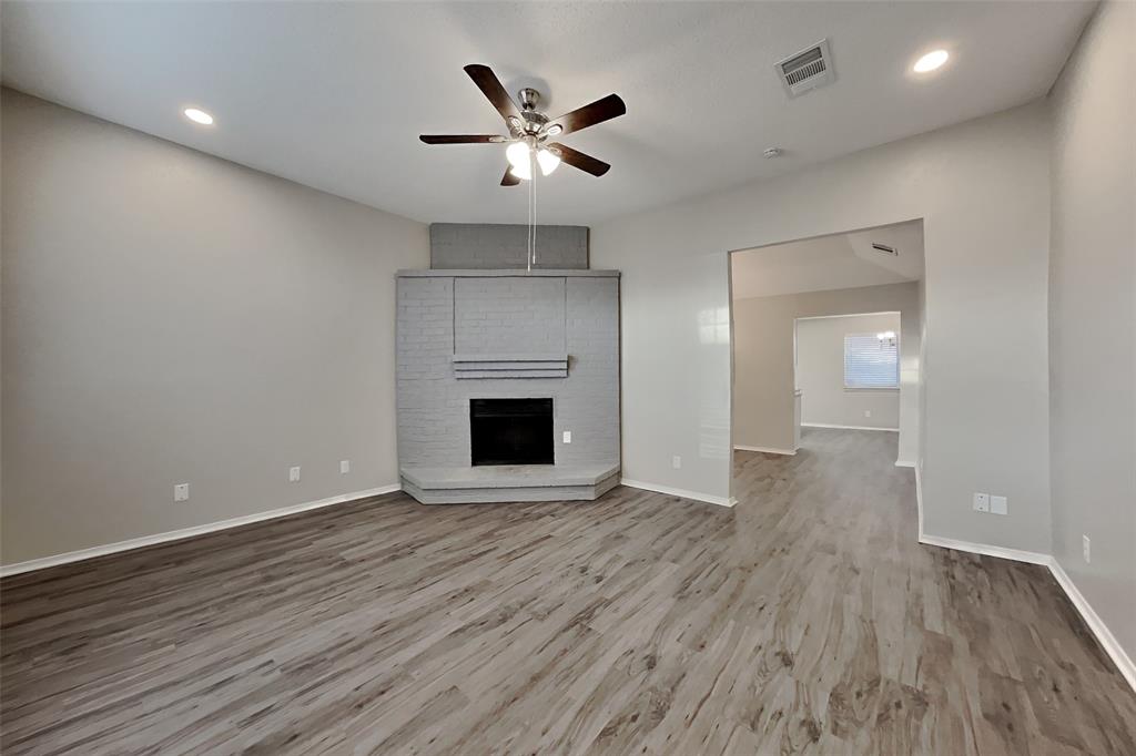 4013 David Circle Rowlett, TX 75088 - Photo 3 of 19 an empty room with wooden floor and a ceiling fan