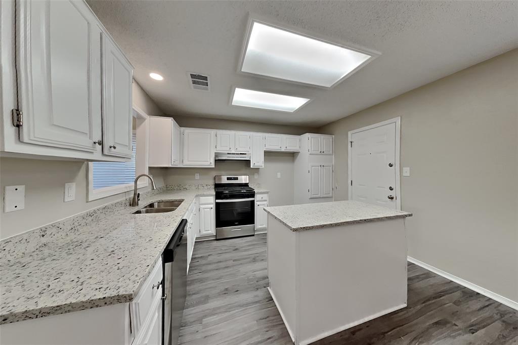 4013 David Circle Rowlett, TX 75088 - Photo 4 of 19 a kitchen with a sink stove and cabinets
