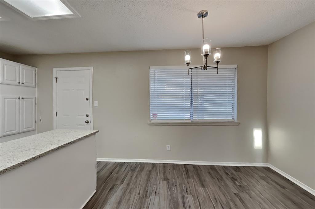 4013 David Circle Rowlett, TX 75088 - Photo 5 of 19 an empty room with wooden floor and windows