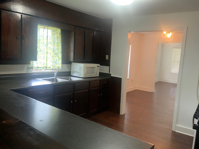 850 Slade Street Coldspring, TX 77331 - Photo 11 of 31 a kitchen with granite countertop a sink and a refrigerator