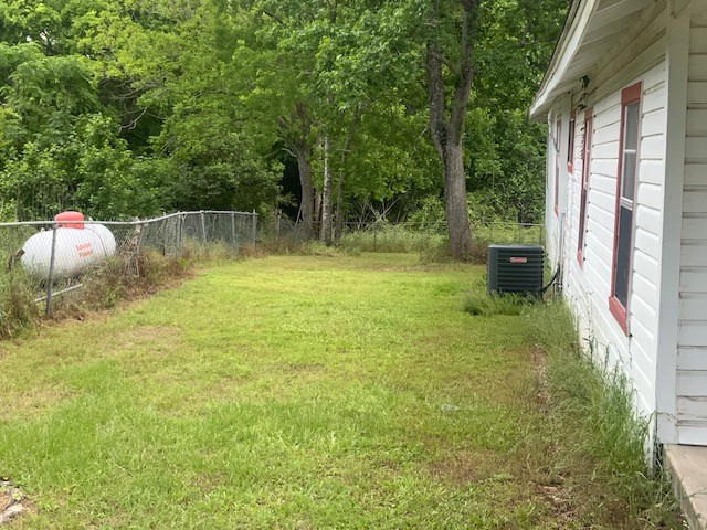 850 Slade Street Coldspring, TX 77331 - Photo 28 of 31 a backyard of a house with lots of green space and fountain