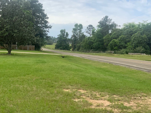 850 Slade Street Coldspring, TX 77331 - Photo 29 of 31 a view of a green field with trees in the background