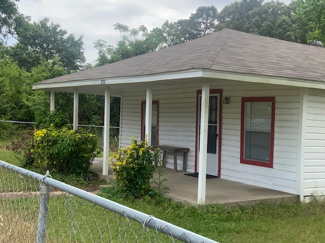 850 Slade Street Coldspring, TX 77331 - Photo 3 of 31 a view of a white house with large windows and plants