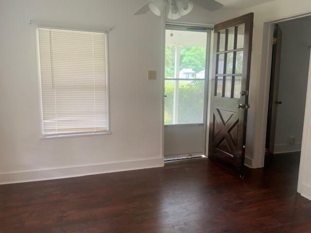 850 Slade Street Coldspring, TX 77331 - Photo 5 of 31 a view of an empty room with wooden floor and a window