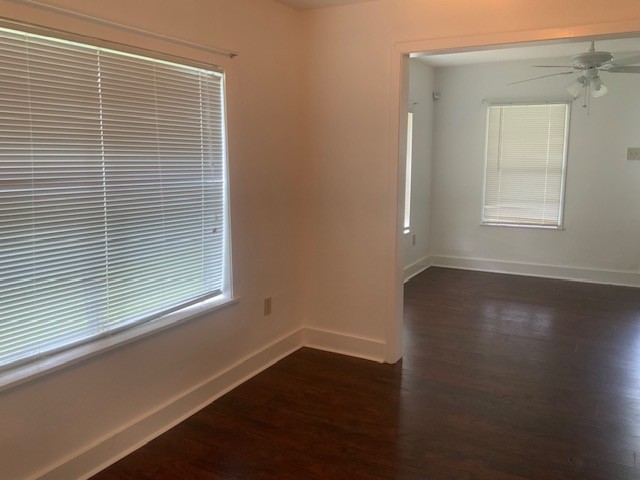 850 Slade Street Coldspring, TX 77331 - Photo 8 of 31 a view of an empty room with wooden floor and a window