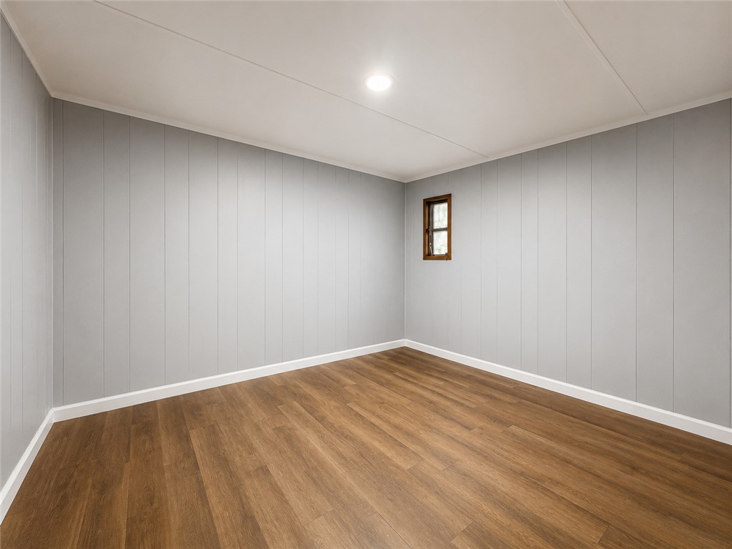 3301 Dixon Road Anderson, SC 29625 - Photo 14 of 20 Warm wood flooring extends throughout this versatile space, featuring a single window and paneling.