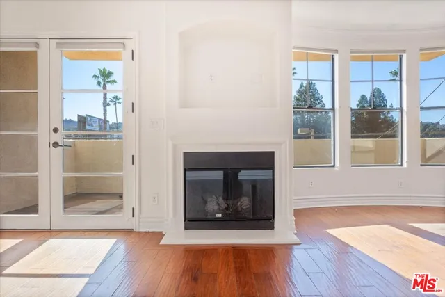 a living room with a fireplace and a wooden floor