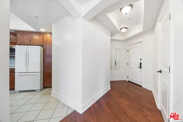 a view of a kitchen with a refrigerator and a microwave