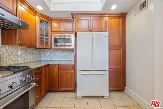 a kitchen with a refrigerator and a stove