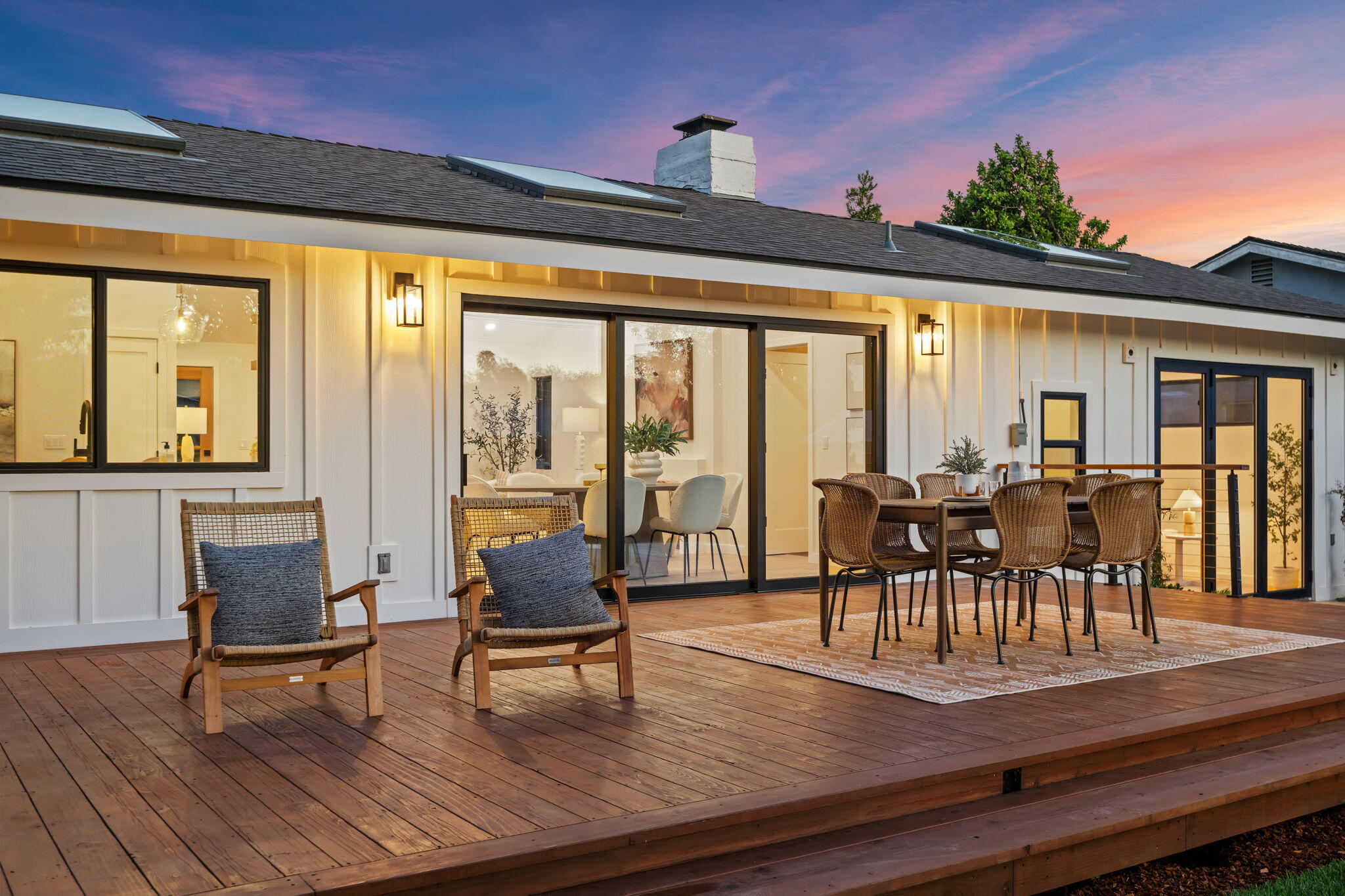 501 Northview Road Santa Barbara, CA 93105 - Photo 22 of 31 a dining room with wooden floor a chandelier a glass table and chairs