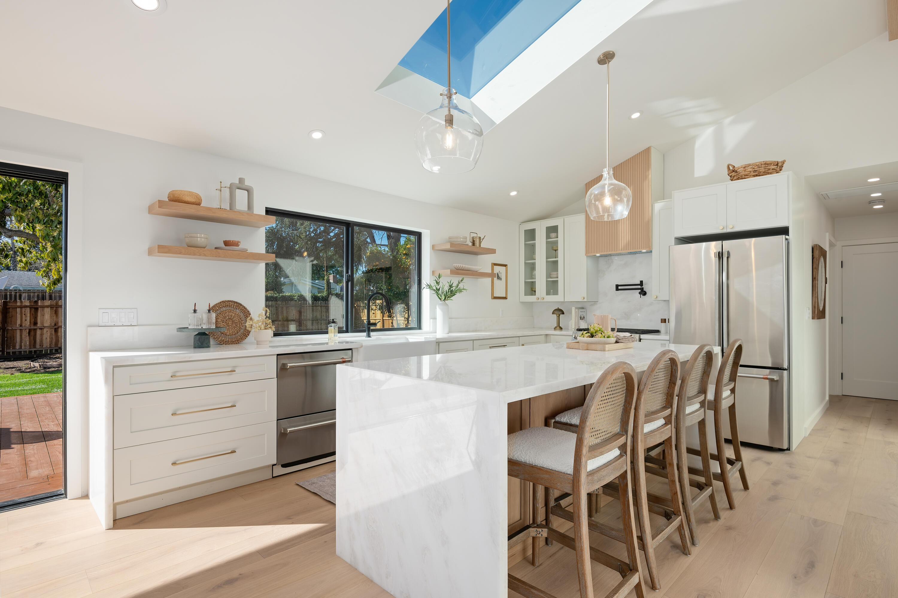 501 Northview Road Santa Barbara, CA 93105 - Photo 9 of 31 a kitchen with stainless steel appliances kitchen island granite countertop a table chairs sink and cabinets