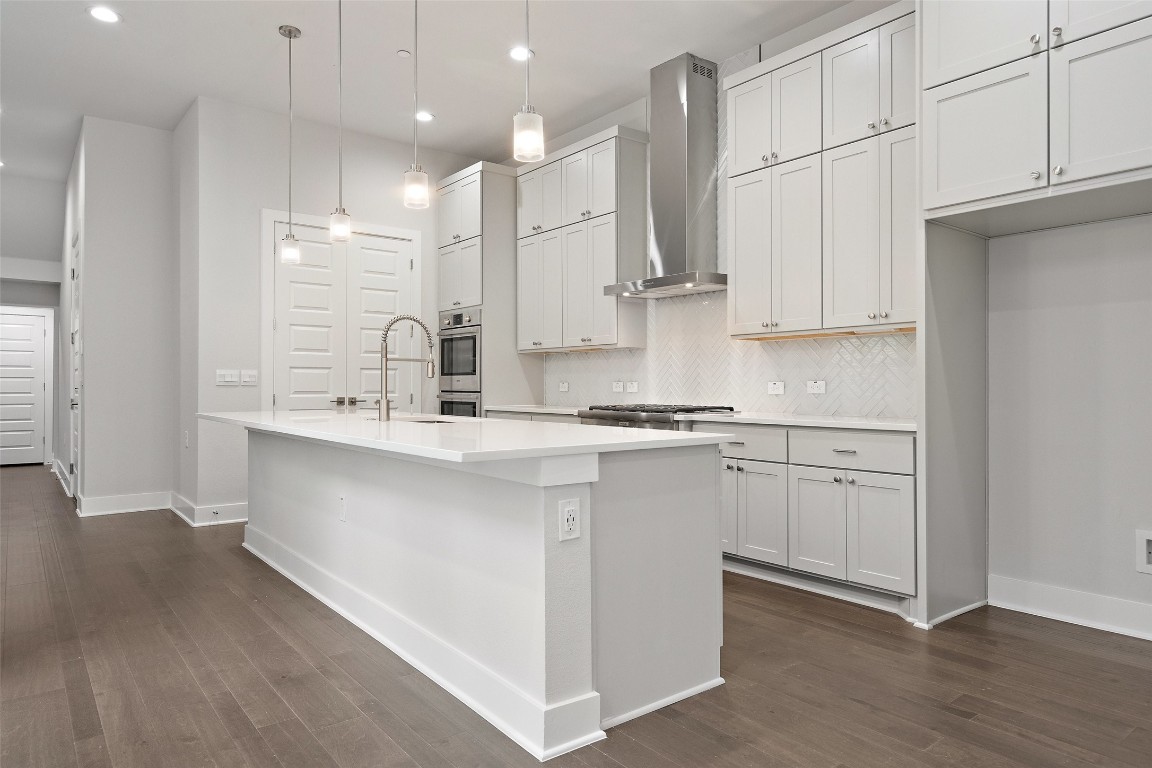 a kitchen with kitchen island white cabinets and white appliances