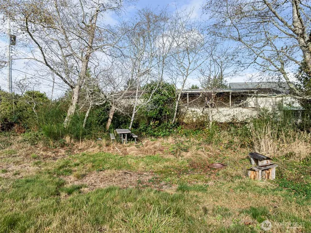 a backyard of a house with table and chairs