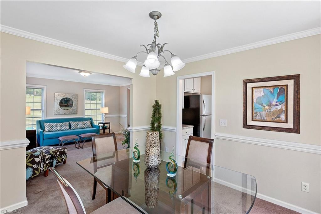 1117 Tangle Lane High Point, NC 27265 - Photo 29 of 29 Open floor plan from the formal dining room to the formal living room. Crown molding and bay window are a nice accent to the formal dining room.