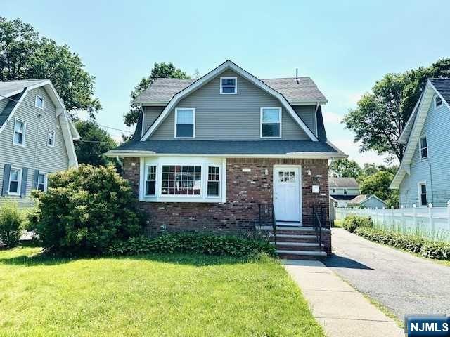 1249 Beaumont Avenue Teaneck, NJ 07666 - Photo 1 of 23 a front view of a house with garden