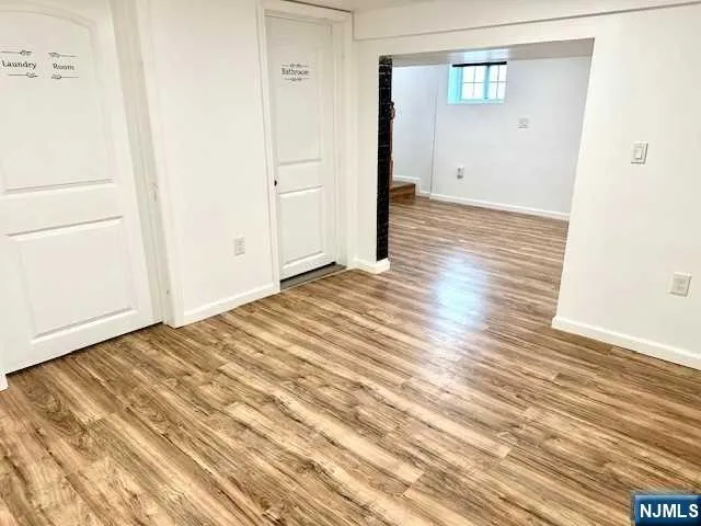 a view of a room with wooden floor and white doors