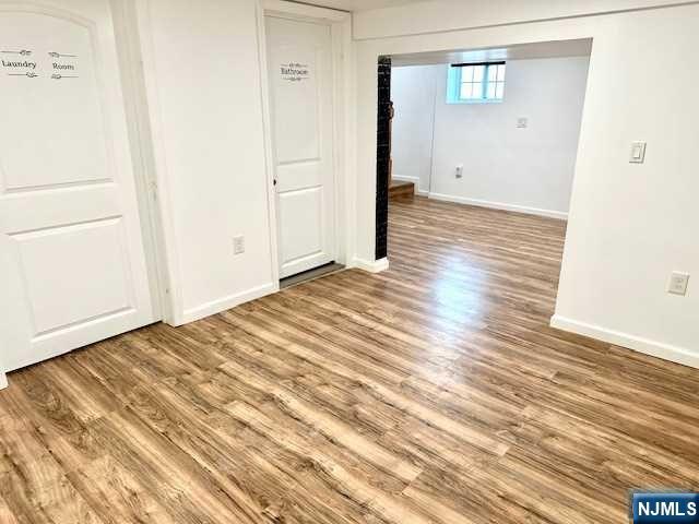 1249 Beaumont Avenue Teaneck, NJ 07666 - Photo 17 of 23 a view of a room with wooden floor and white doors