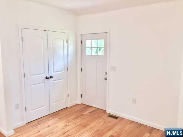 1249 Beaumont Avenue Teaneck, NJ 07666 - Photo 2 of 23 a view of an empty room with wooden floor
