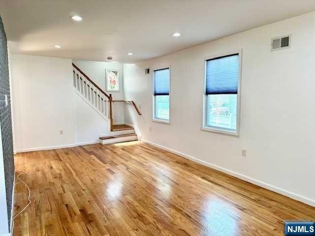 1249 Beaumont Avenue Teaneck, NJ 07666 - Photo 4 of 23 a view of a hallway with wooden floor and staircase