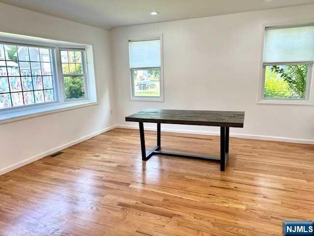 1249 Beaumont Avenue Teaneck, NJ 07666 - Photo 5 of 23 a view of an empty room with wooden floor and a window
