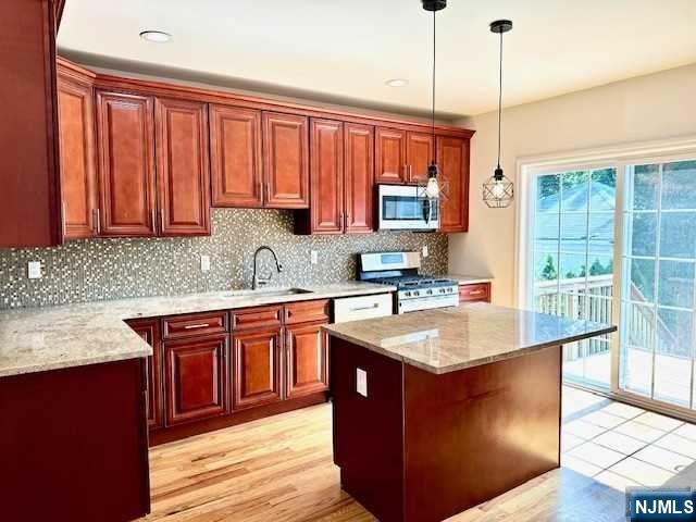 1249 Beaumont Avenue Teaneck, NJ 07666 - Photo 9 of 23 a kitchen with stainless steel appliances granite countertop wooden cabinets a sink and dishwasher