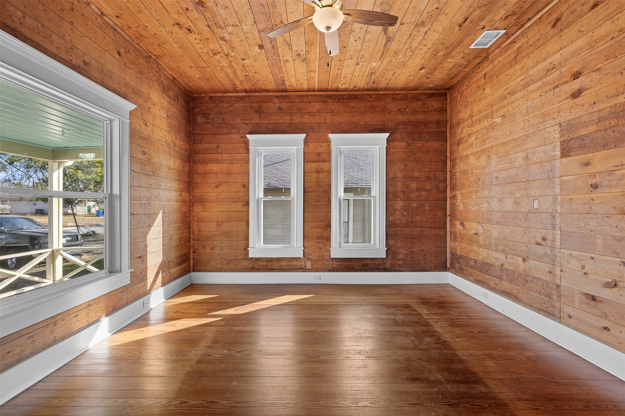 1019 West 4th Street Taylor, TX 76574 - Photo 11 of 20 a view of an empty room with wooden floor and a window