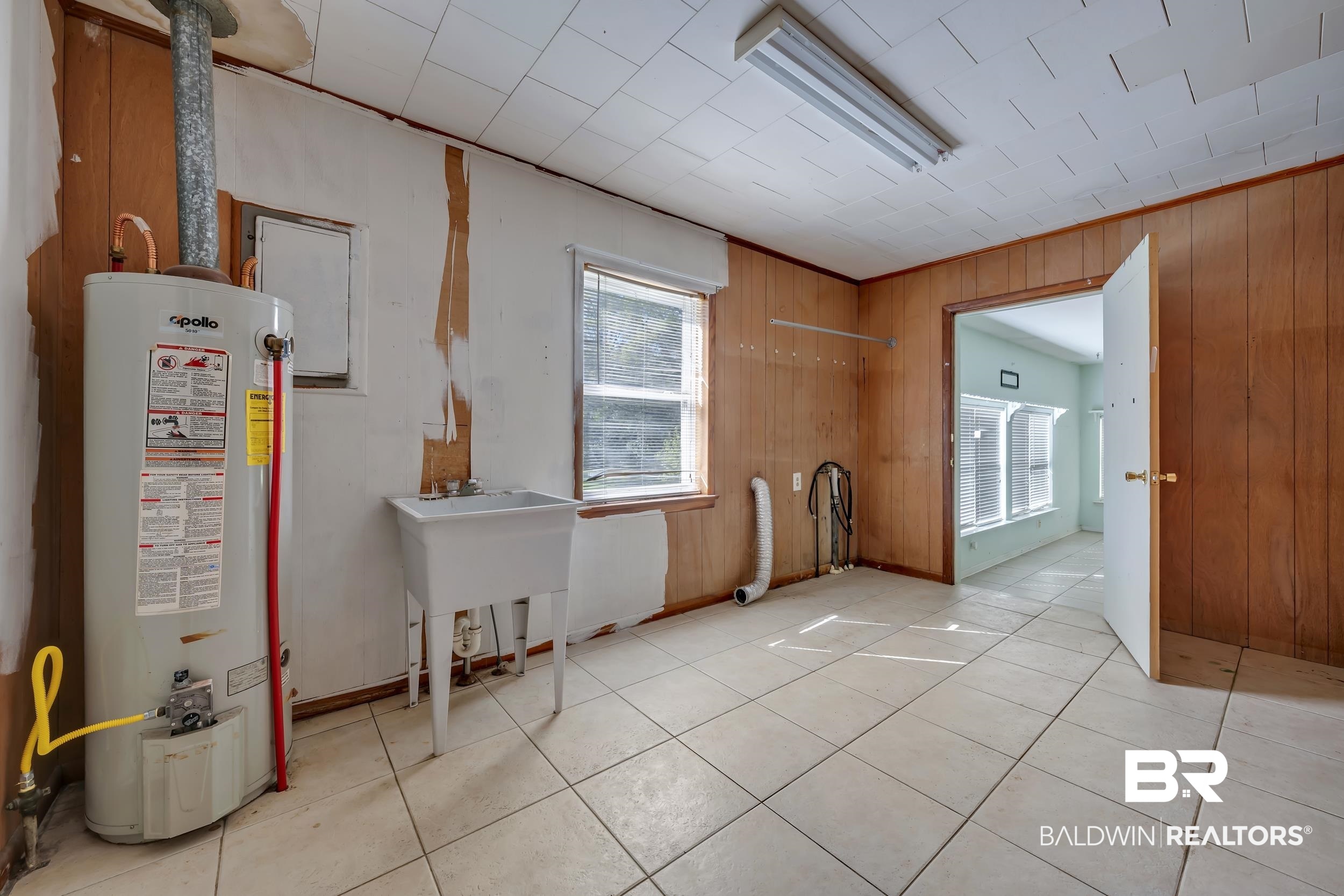 17463 Highway 98 Foley, AL 36535 - Photo 5 of 57 Spare room with gas water heater, light tile patterned floors, and wooden walls