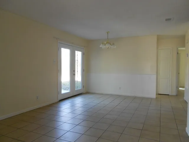 an empty room with a empty space and windows