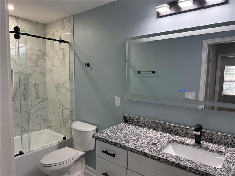 1202 Pisgah Road Southwest Austell, GA 30168 - Photo 11 of 30 a bathroom with a granite countertop sink toilet and shower