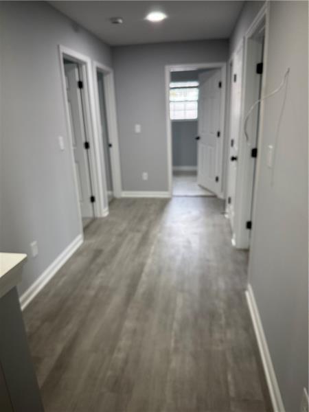 1202 Pisgah Road Southwest Austell, GA 30168 - Photo 16 of 30 a view of a hallway with wooden floor and a bathroom