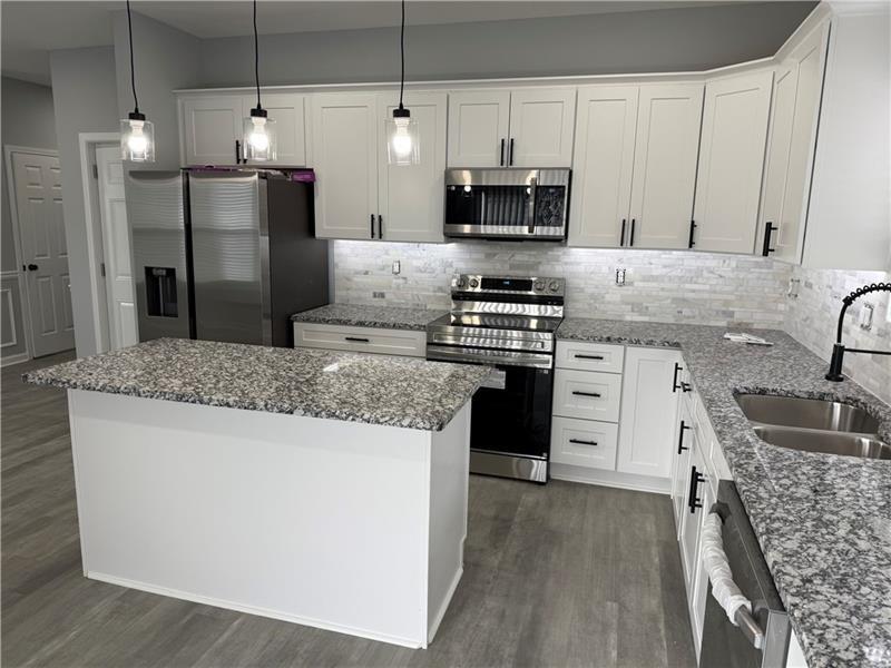 1202 Pisgah Road Southwest Austell, GA 30168 - Photo 22 of 30 a kitchen with stainless steel appliances granite countertop a sink stove and refrigerator