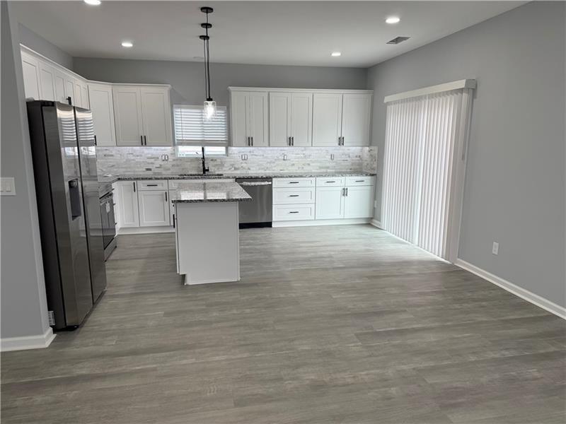 1202 Pisgah Road Southwest Austell, GA 30168 - Photo 30 of 30 a large kitchen with kitchen island a sink a center island stainless steel appliances and a cabinets