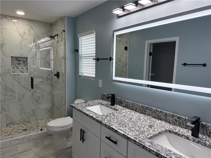 1202 Pisgah Road Southwest Austell, GA 30168 - Photo 5 of 30 a bathroom with a granite countertop sink toilet and shower