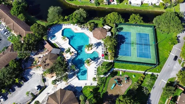 an aerial view of a house with a yard and plants
