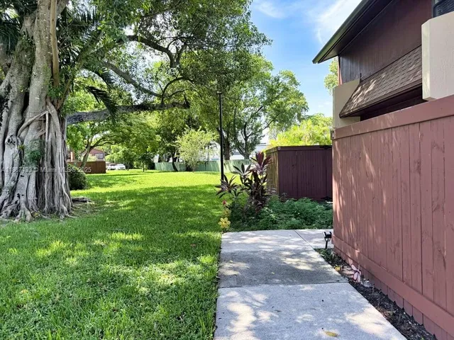 a view of a backyard with a tree