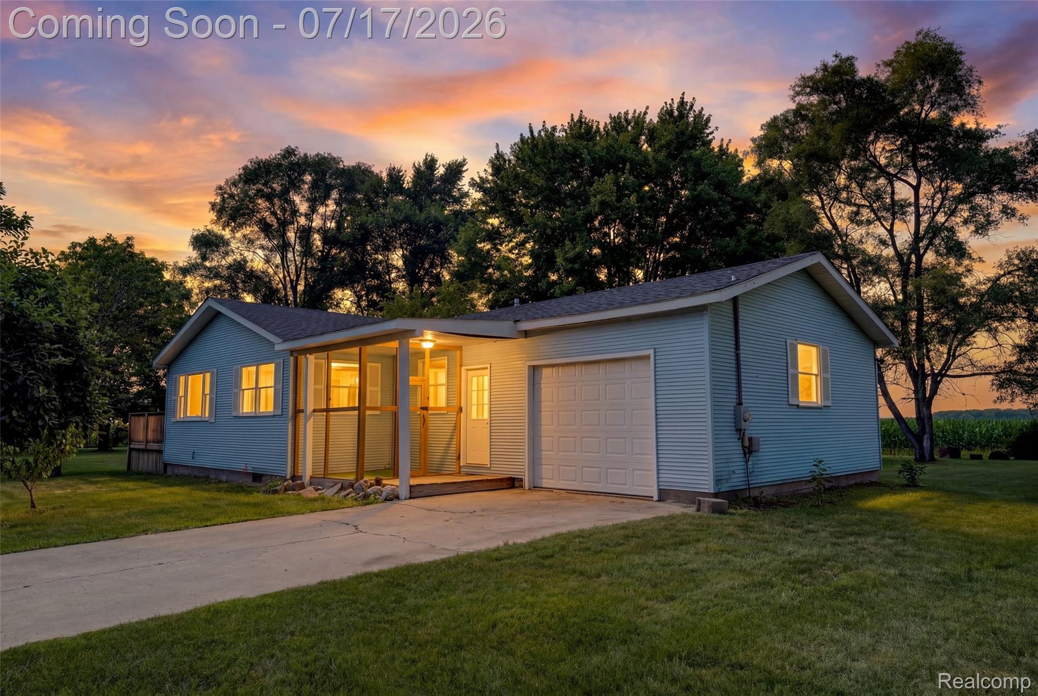 9204 Bray Road Millington, MI 48746 - Photo 1 of 14 Single-story residence featuring light blue siding and a covered, screened-in porch