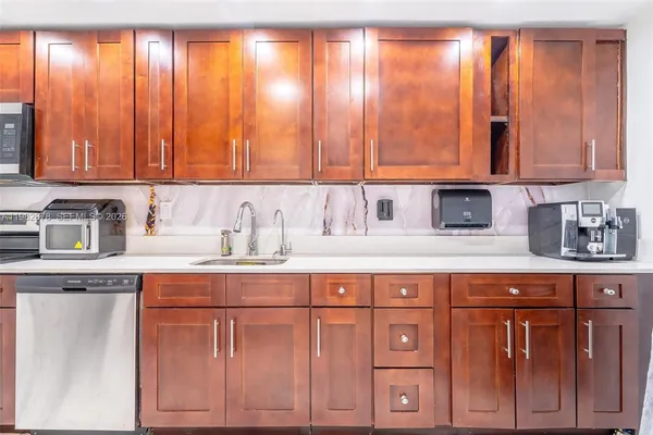 a front view of a house with plants