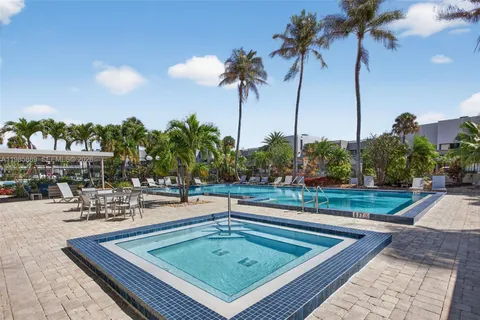 a view of a swimming pool with a table and chairs