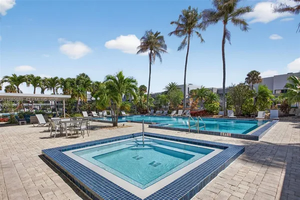 a view of a swimming pool with a table and chairs