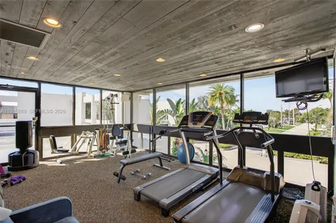 a room with gym equipment and a large window